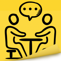 Two People Sitting At A Table Speaking